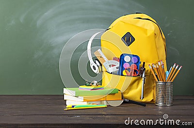 Backpack, textbooks, stationery and school supplies on desk Stock Photo