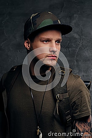 Backpacker in Camo green t shirt and tattoos on arms. Stock Photo