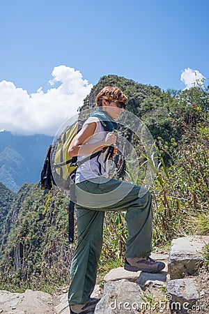 Backpacker exploring the steep Inca Trail of Machu Picchu, the most visited travel destination in Peru. Summer adventures in South Stock Photo