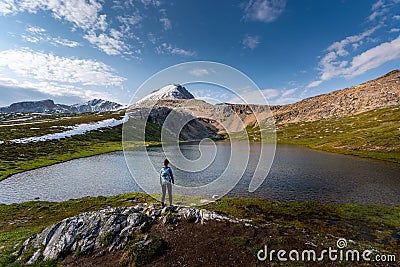 Backpacker Girl admires beautiful Helen Lake and Cirque Peak Banff National Park Alberta Stock Photo