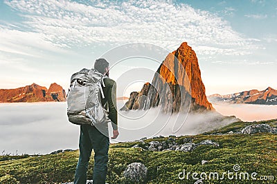 Backpacker man exploring sunset rocky mountains Stock Photo