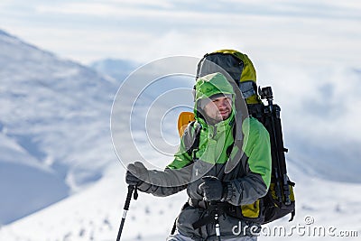 Backpacker is posing in winter mountains Stock Photo