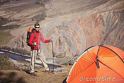 Backpacker with poles in hand. Stock Photo