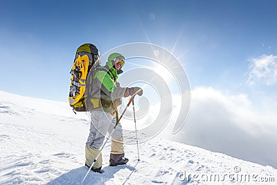 Backpacker is posing in winter mountains Stock Photo