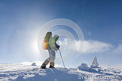 Backpacker is posing in winter mountains Stock Photo