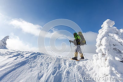 Backpacker is posing in winter mountains Stock Photo