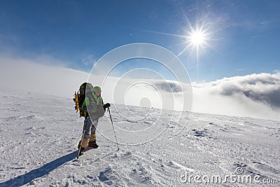 Backpacker is posing in winter mountains Stock Photo