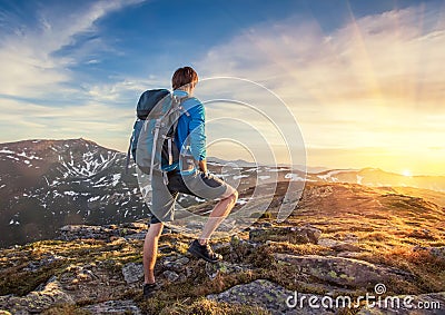 Backpacker on top of a mountaine Stock Photo