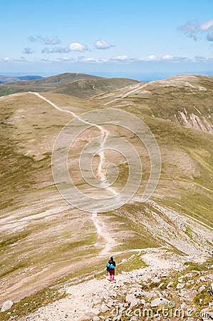 Backpacker walking in the Mountains Stock Photo