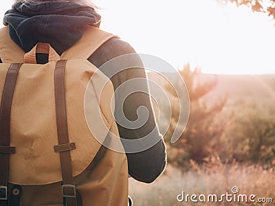 Backpacker woman on journey. Rear view of traveler woman. Stock Photo