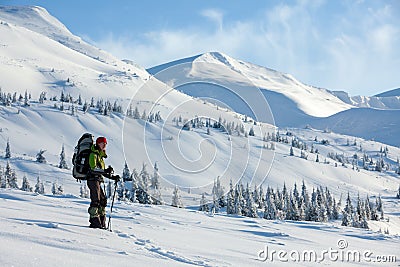 Backpacker woman posing in winter mountains Stock Photo