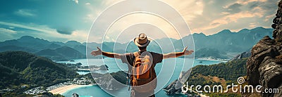 Backpackers joy: Young man stands arms wide, atop a scenic mountain Stock Photo