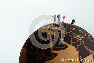 Backpackers on top of the Globe. Travel concept Stock Photo