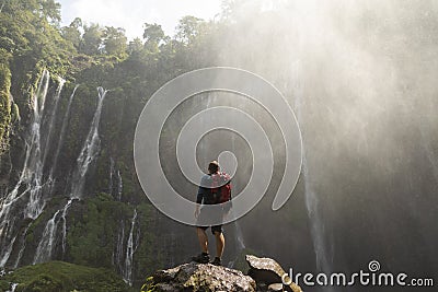 A backpacking adventurer gazes in Sewu waterfalls, Indonesia Editorial Stock Photo