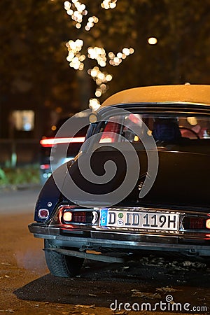 Backside of an old black Citroen DS classic car at night in Duesseldorf, Germany. Editorial Stock Photo