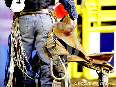 Backside of a Rodeo Cowboy with his Saddle Stock Photo