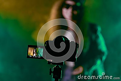 Backstage operator working professional camera. Videographer shoots music clip Stock Photo