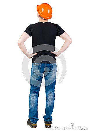 Backview of an engineer in construction helmet stands. Stock Photo