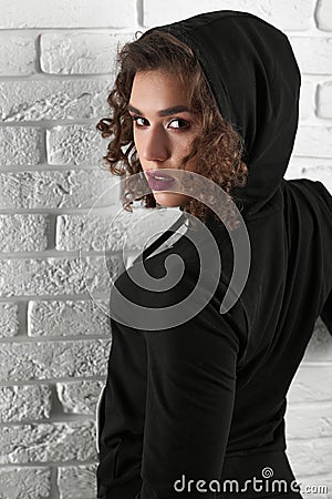 Backview of passionate curly model looking at camera. Stock Photo