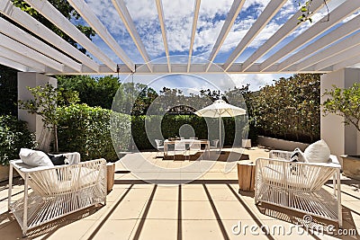 Backyard cozy patio area with wicker furniture set Stock Photo