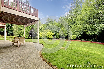 Backyard of the houes with porch and green forest. Stock Photo