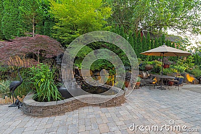 Backyard Landscaping Patio with Waterfall Pond Stock Photo