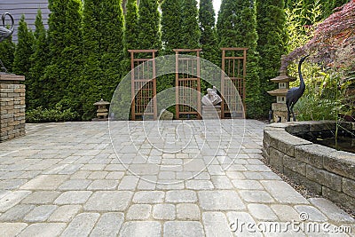 Backyard Paver Patio with Pond in Garden Stock Photo