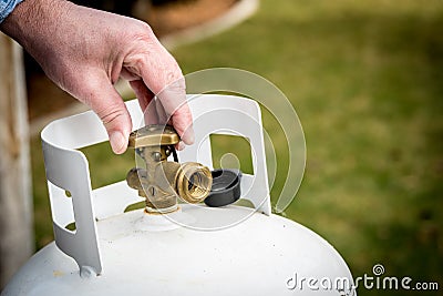 Backyard propane tank valve adjustment Stock Photo