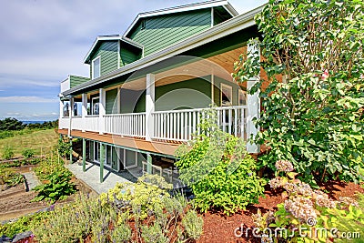 Backyard view of country three story green house Stock Photo