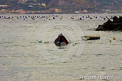 Bacoli, a boat that sinks into the Gulf of Naples after a storm. Stock Photo