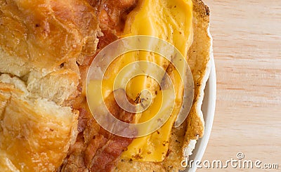 Bacon egg and cheese croissant breakfast sandwich on plate close Stock Photo