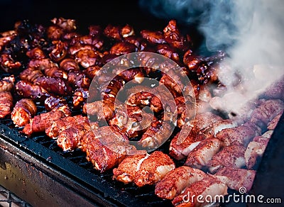 Bacon wrapped shrimp smoking on grill Stock Photo