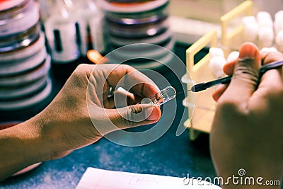 Bacterial Inoculation on a test tube agar culture media using inoculation loop by scientist lab technician in a microbiology labor Stock Photo