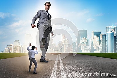 The bad angry boss kicking employee in business concept Stock Photo