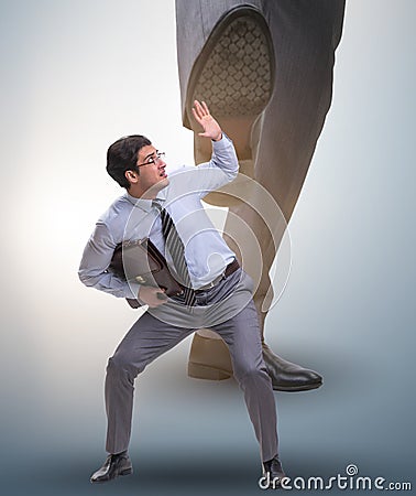 Bad angry boss kicking employee in business concept Stock Photo