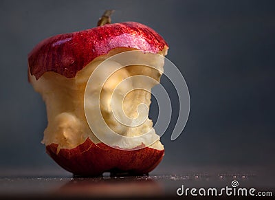 Bad Apple surreal faces carved into the core Stock Photo