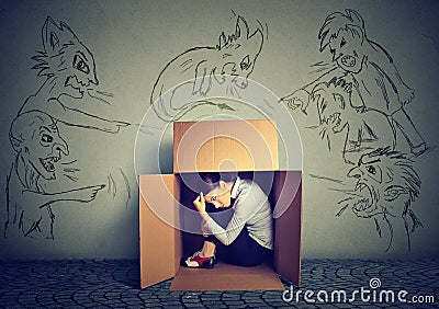 Bad evil men pointing at woman. Girl hiding inside box Stock Photo