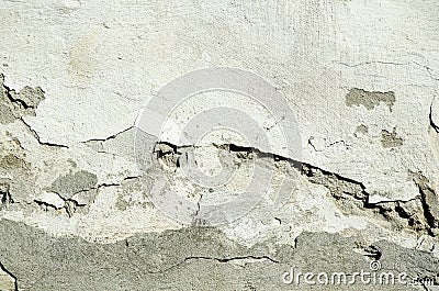 Bad foundation base on old house or building cracked plaster facade wall with brick background Stock Photo