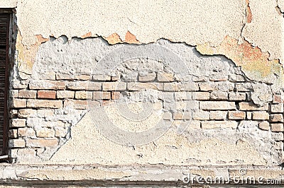 Bad foundation base on old house or building cracked plaster facade wall with brick background Stock Photo