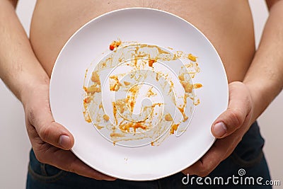 Bad habits, overeat, junk food. Dirty plate with inscription Fat Stock Photo