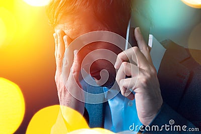 Bad news, businessman conducting unpleasant phone conversation Stock Photo