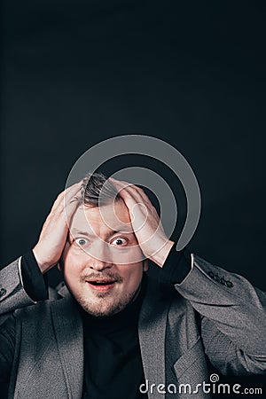 Troubled worried shocked man over black background Stock Photo