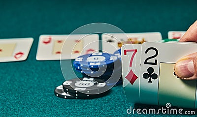 Bad poker gamble or unlucky hand concept with player going all in with 2 and 7 two and seven offsuit also called unsuited, Stock Photo