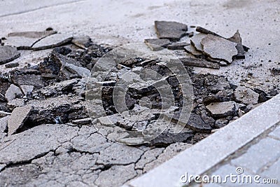 Bad road. Broken asphalt. Stock Photo