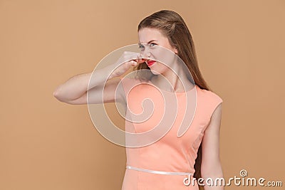 Bad smell, unhappy woman holding her nose. Stock Photo