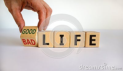 From bad to good life. Hand is turning a cube and changes the words `bad life` to `good life`. Beautiful white background. Stock Photo