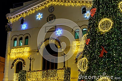 Badalona, Spain November 25, 2023. Festive architecture with illuminated Christmas tree and decoration. Badalona, Spain Editorial Stock Photo