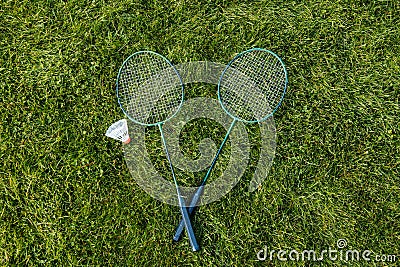 badminton rackets and shuttlecock on grass Stock Photo