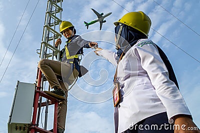 Badung, Bali, Dec 8th 2020: In a clearly day, 2 female technical workers repairing communication equipment at the airport. One of Editorial Stock Photo