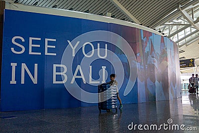 BADUNG,BALI/INDONESIA-June 25 2018: Little boy brings his own suitcase alone to departure terminal in Ngurah Rai Bali Editorial Stock Photo